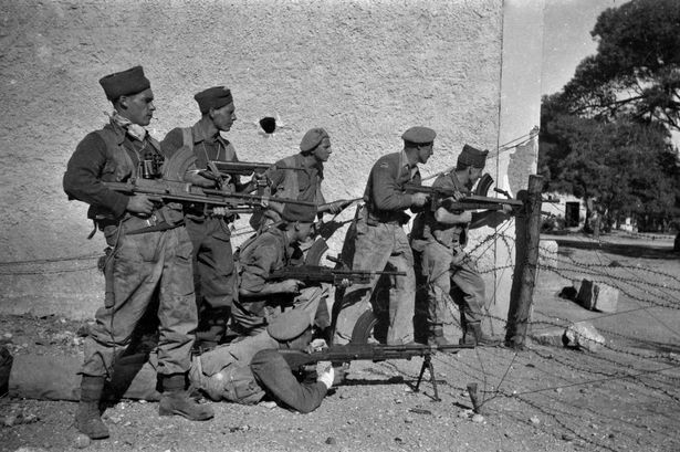 Black and white photo of men with guns